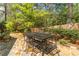 Flagstone patio with dining set amidst lush greenery and a wooden fence for a private outdoor space at 129 Ridgetree Ln, Marietta, GA 30068