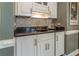 Stylish wet bar with granite counters, cabinet storage, and decorative backsplash at 129 Ridgetree Ln, Marietta, GA 30068