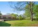 Expansive backyard with mature trees, lush lawn, and concrete patio at 566 Huff St, Lawrenceville, GA 30046