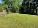 Expansive backyard with a well-kept lawn, partial fence, and plenty of space for recreation at 566 Huff St, Lawrenceville, GA 30046