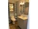 Bathroom with a vanity, toilet, and shelving, providing ample storage space and convenience at 566 Huff St, Lawrenceville, GA 30046