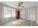 Bright bedroom features wood-look flooring, a ceiling fan, and lots of natural light at 566 Huff St, Lawrenceville, GA 30046