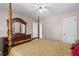 Bedroom showcasing a four-poster bed, a dresser with a mirror, and neutral wall colors at 566 Huff St, Lawrenceville, GA 30046