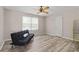 Bedroom featuring a futon, a ceiling fan, and wood-look flooring at 566 Huff St, Lawrenceville, GA 30046