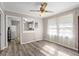 Bright dining room with wood-look flooring, ceiling fan, and pass-through to the kitchen at 566 Huff St, Lawrenceville, GA 30046