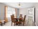 Charming dining room boasts wood floors, wainscoting, and a view into the bathroom at 566 Huff St, Lawrenceville, GA 30046