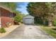 A long driveway leads to a detached one-car garage, next to the brick home at 566 Huff St, Lawrenceville, GA 30046