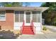 Entryway to the brick home, with red stairs and a white trimmed door at 566 Huff St, Lawrenceville, GA 30046