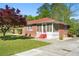 Charming brick home with a screened-in porch and a well-manicured lawn at 566 Huff St, Lawrenceville, GA 30046