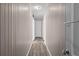 Hallway with wood-look flooring and neutral-colored walls with molding at 566 Huff St, Lawrenceville, GA 30046