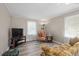 Inviting living room offers a neutral color palette, wood-look floors, and plenty of natural light at 566 Huff St, Lawrenceville, GA 30046
