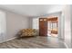Comfortable living room with wood-look flooring, neutral walls, and a door to the sunroom at 566 Huff St, Lawrenceville, GA 30046