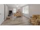 Cozy living room features bright windows, wood-look flooring, and a ceiling fan at 566 Huff St, Lawrenceville, GA 30046