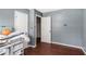 Bedroom featuring wood floors and three doorways at 1302 Brittain Rd, Douglasville, GA 30134