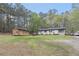 Scenic property featuring a house, shed, and a spacious grassy area at 1302 Brittain Rd, Douglasville, GA 30134