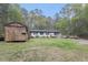 Spacious lot with a house, utility shed, and ample green space at 1302 Brittain Rd, Douglasville, GA 30134
