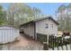 Home exterior with mature trees, white picket fence, and storage shed at 1302 Brittain Rd, Douglasville, GA 30134