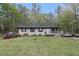 Charming ranch-style home with a well-maintained lawn and mature trees at 1302 Brittain Rd, Douglasville, GA 30134