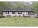 Inviting single-story home featuring a welcoming porch and well-kept yard at 1302 Brittain Rd, Douglasville, GA 30134