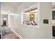 Hallway showcasing a glimpse into the kitchen, hardwood flooring, and neutral paint at 1302 Brittain Rd, Douglasville, GA 30134