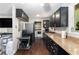 Modern kitchen with granite countertops, stainless steel appliances, and black cabinetry at 1302 Brittain Rd, Douglasville, GA 30134
