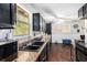 Kitchen featuring black cabinetry, stainless steel appliances, and natural light from the window at 1302 Brittain Rd, Douglasville, GA 30134