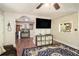 Open-concept living area featuring a large TV, dark hardwood flooring, and an aquarium in the background at 1302 Brittain Rd, Douglasville, GA 30134