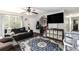 Inviting living area featuring a large sectional sofa and a ceiling fan at 1302 Brittain Rd, Douglasville, GA 30134