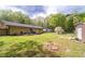 Spacious backyard with a deck, multiple storage sheds, and mature trees at 284 Zion Wood Rd, Loganville, GA 30052