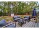 Backyard deck with comfortable seating, a shed, and a green, tree-lined backdrop at 284 Zion Wood Rd, Loganville, GA 30052