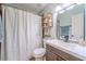 Bathroom featuring a shower with curtain, modern vanity, and tasteful decor, offering a relaxing atmosphere at 284 Zion Wood Rd, Loganville, GA 30052