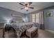 Bedroom with blue walls, a queen bed, and a bench with a throw blanket at 284 Zion Wood Rd, Loganville, GA 30052