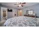 Bedroom featuring blue walls, a queen bed, and an attached bathroom at 284 Zion Wood Rd, Loganville, GA 30052
