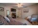 Comfortable bedroom featuring a ceiling fan, neutral walls, and a cozy chair at 284 Zion Wood Rd, Loganville, GA 30052