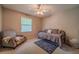 Bright bedroom with neutral carpet, natural light, and a cozy daybed with an armchair at 284 Zion Wood Rd, Loganville, GA 30052