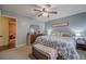 Bedroom featuring light blue walls, a queen bed, and a dresser with mirror at 284 Zion Wood Rd, Loganville, GA 30052