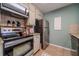 Efficient kitchen featuring stainless steel appliances, ample storage, and a light green accent wall at 284 Zion Wood Rd, Loganville, GA 30052