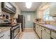 Well-lit kitchen featuring modern appliances, granite countertops, and ample cabinet space for storage at 284 Zion Wood Rd, Loganville, GA 30052