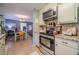 Bright kitchen with granite countertops, stainless steel appliances, and an open view to the adjacent dining area at 284 Zion Wood Rd, Loganville, GA 30052
