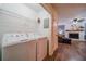Laundry room featuring a modern washer and dryer set, with a glimpse into the adjacent living area at 284 Zion Wood Rd, Loganville, GA 30052