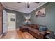 Cozy living room showcasing a plush sectional sofa, hardwood flooring, and access to another room at 284 Zion Wood Rd, Loganville, GA 30052
