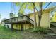 Back of home shows a large wooden deck, steps down to the yard, and a brick exterior at 3150 Stonewall Tell Rd, Atlanta, GA 30349