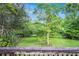 Picturesque backyard view from wooden deck, showcasing lush greenery and mature trees for added privacy at 3150 Stonewall Tell Rd, Atlanta, GA 30349