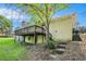 A brick home featuring a wooden deck, stairs leading up to the home, and a sloped lawn at 3150 Stonewall Tell Rd, Atlanta, GA 30349