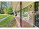 Cozy covered porch features decorative iron supports, classic brickwork, and a secure entryway, creating an inviting facade at 3150 Stonewall Tell Rd, Atlanta, GA 30349