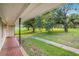 Inviting covered porch with decorative tile flooring, perfect for enjoying views of the lush, green front yard at 3150 Stonewall Tell Rd, Atlanta, GA 30349