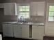 Functional kitchen featuring white cabinets and ample counter space at 3347 Sir Lancelot Sw Pl, Marietta, GA 30008