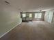 Inviting living room and kitchen area featuring neutral paint and a ceiling fan at 3347 Sir Lancelot Sw Pl, Marietta, GA 30008