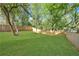 A large, fenced backyard features a lush lawn and mature trees at 644 Glendale Rd, Scottdale, GA 30079