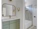 Modern bathroom with olive vanity, gold fixtures, and a tiled shower and tub combo at 644 Glendale Rd, Scottdale, GA 30079